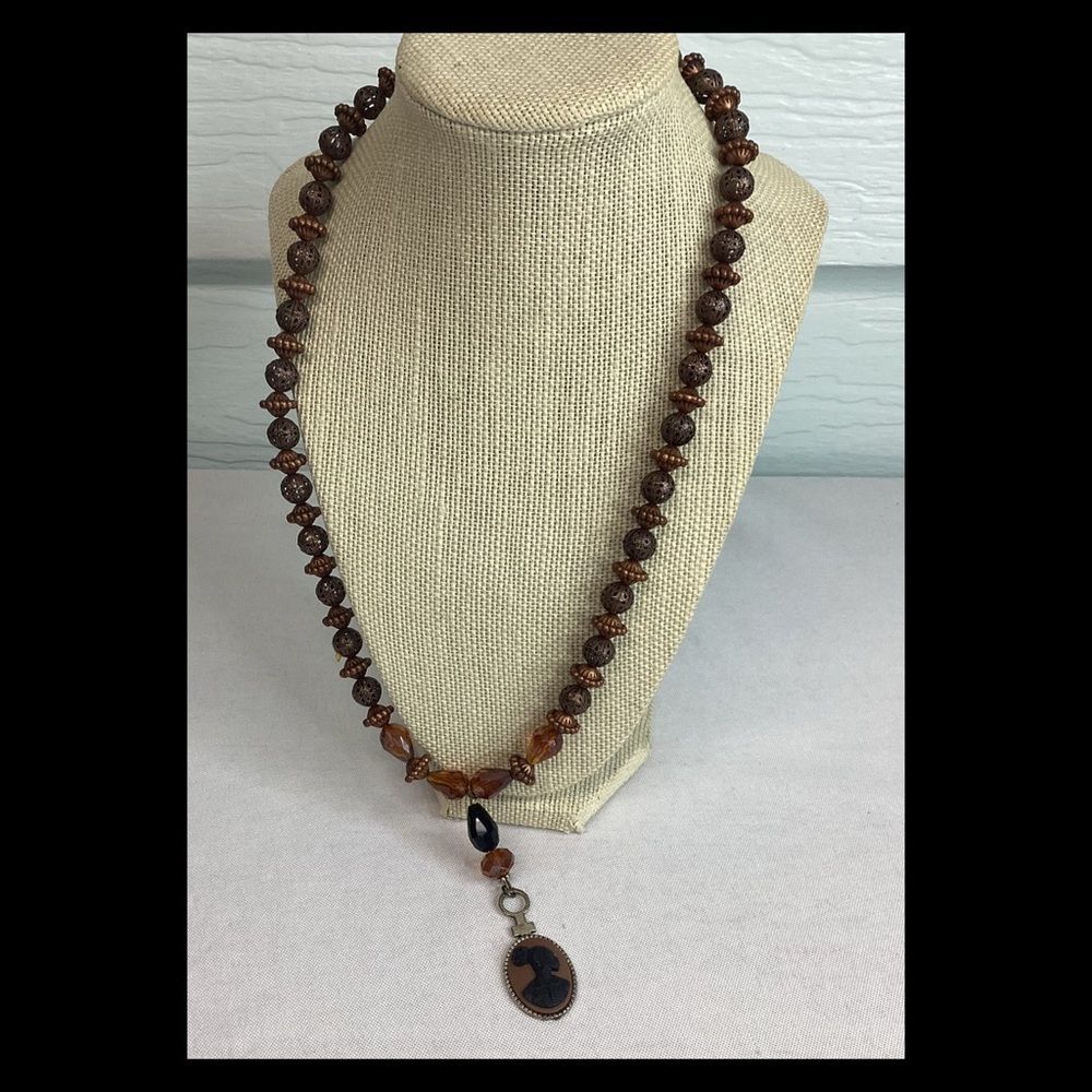 Brown beaded cameo necklace.